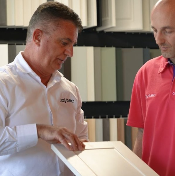 A polytec representative showing door and panel samples to a customer