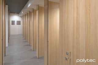 polytec COMMERCIAL & ARCHITECTURAL - Partition System  in Full Height - Unisex - Ceiling Fixed,  with Natural Oak Ravine.