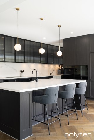 polytec KITCHEN - Doors & panels in Hampton,  with Tempest Woodgrain, Overhead doors in 23mm Brushed Black Frame,  with Fluted Glass Insert.
