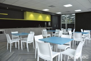 polytec COMMERCIAL & ARCHITECTURAL - Laminate benchtop in Visoni Stone Matt, Table tops in Peacock Oak Ravine, Overhead doors and shelving in Citrine Oak Ravine, Cupboard doors in Black Wenge Ravine.