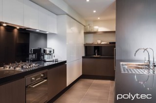 Polytec - CREATEC overhead doors and pantry in New Ultra White Gloss, Base cabinets and shelving in Truffle Lini Matt.
